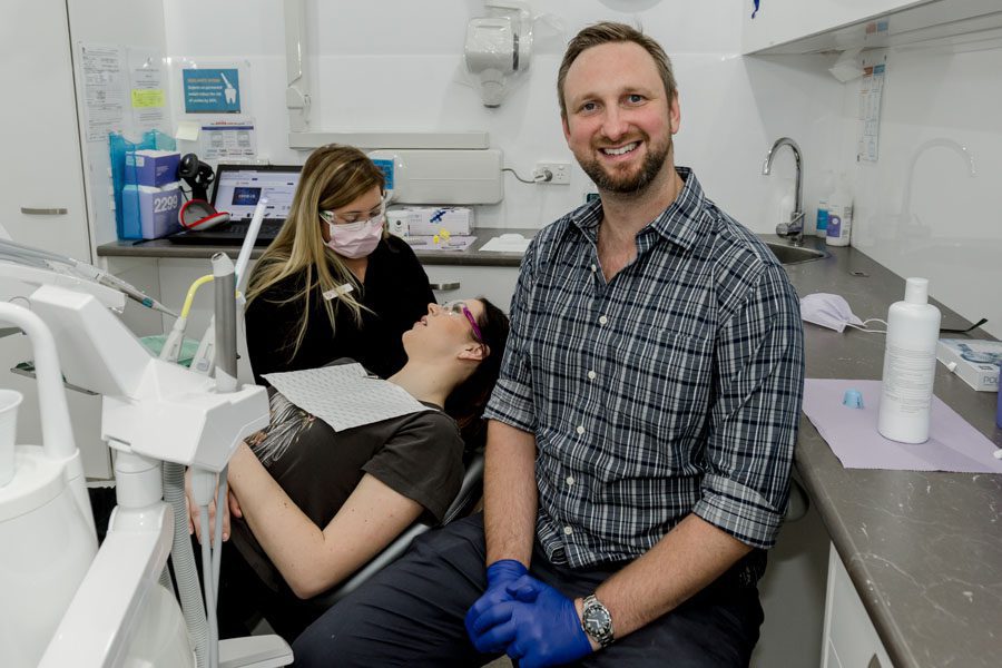 dentist and dental assistant with female patient